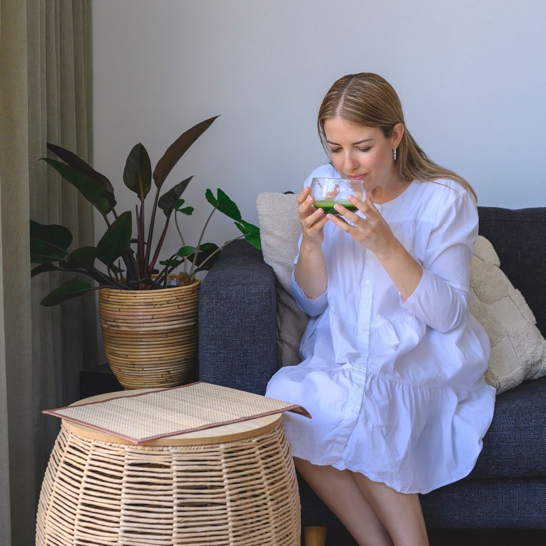 The Truth about Ceremonial Grade Matcha - Woman Enjoying Matcha in Glass Bowl