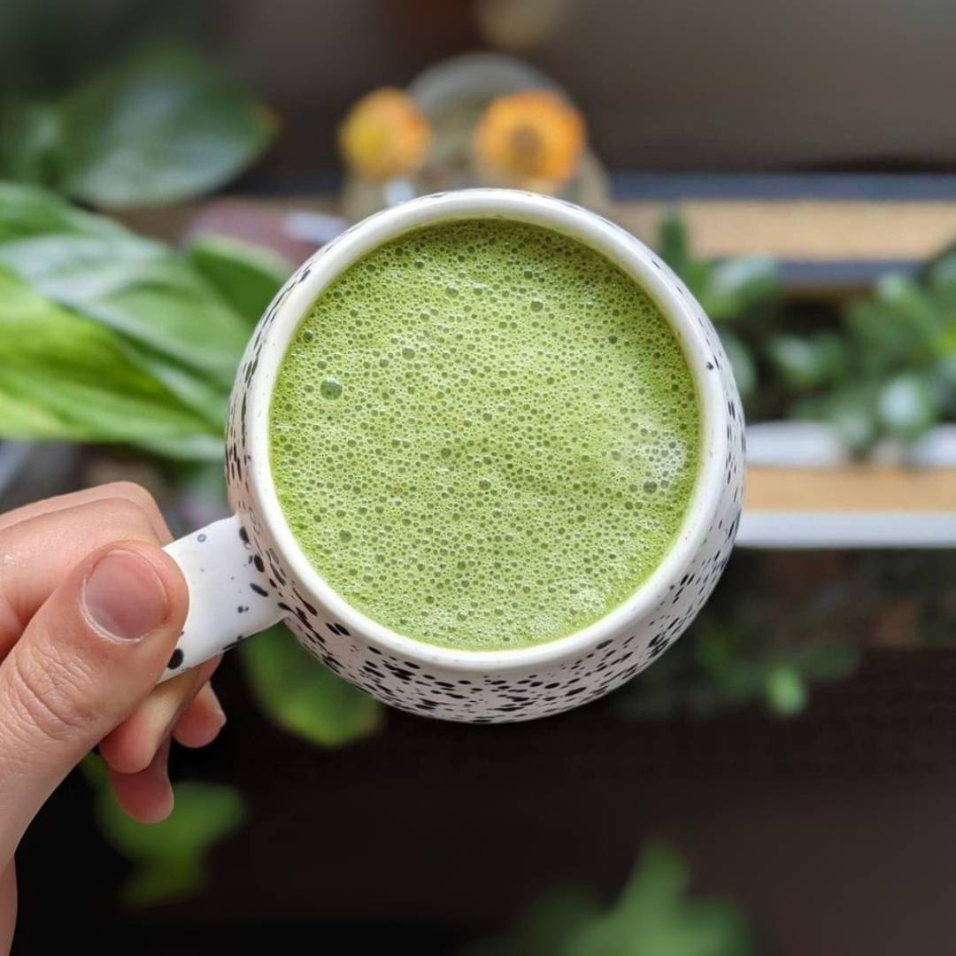 Hot Matcha Latte being held in hands