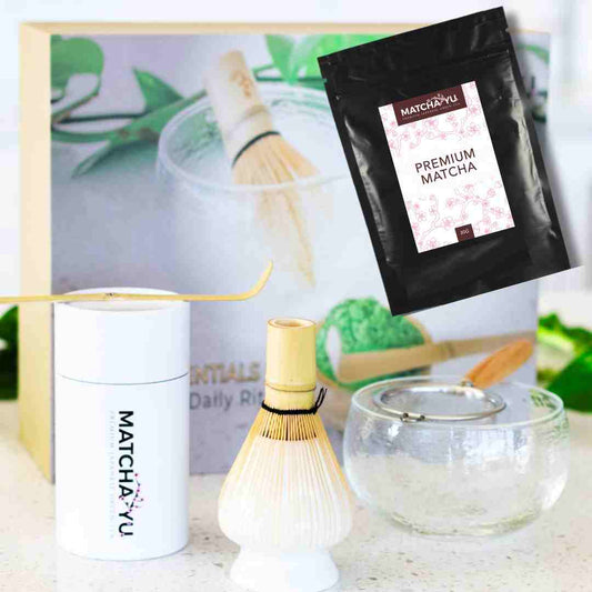 Matcha-yu premium matcha packaging with a whisk and bowl on a light surface.