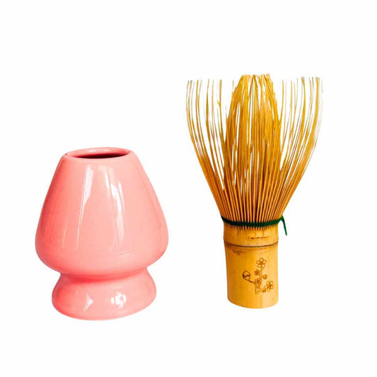 Pink ceramic whisk and wooden whisk on a white background