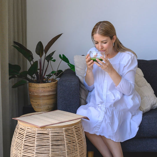 The Truth about Ceremonial Grade Matcha - Woman Enjoying Matcha in Glass Bowl