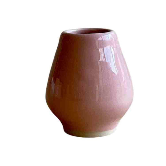 Pink ceramic holder on a white background