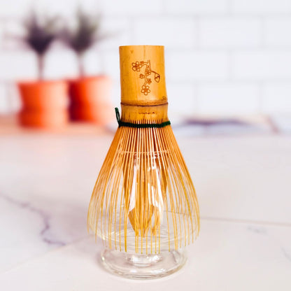Bamboo whisk with glass base on a blurred background