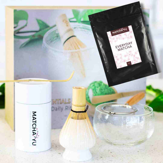 Matcha preparation set with Matché-Yu packaging and matcha accessories on a light background