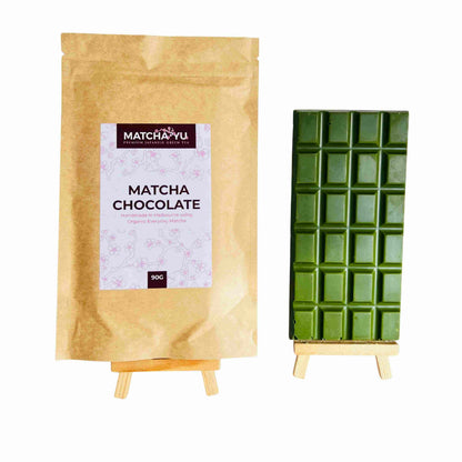Matcha chocolate packaging with a wooden stand on a white background