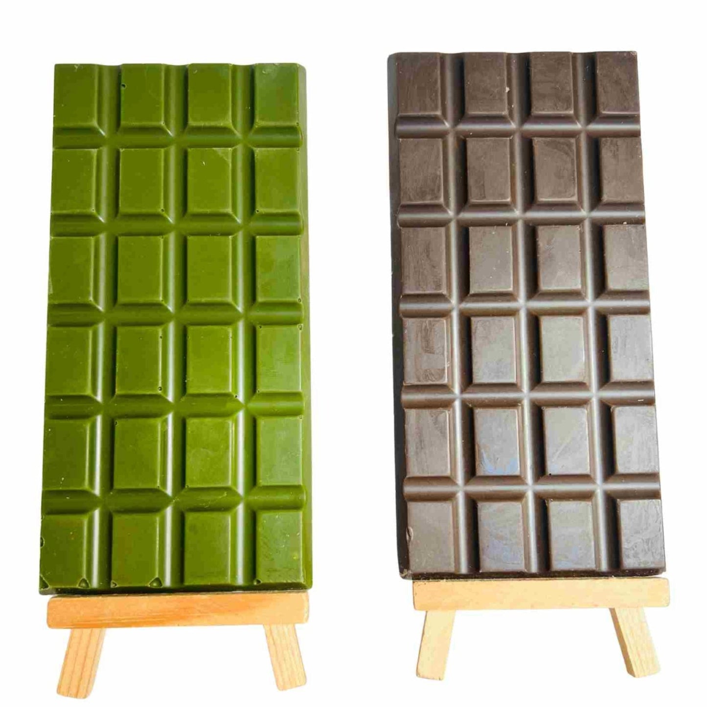 Two chocolate bars on stands, one green and one brown, against a white background