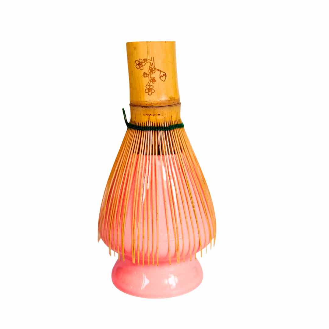 Bamboo whisk with pink base on a white background