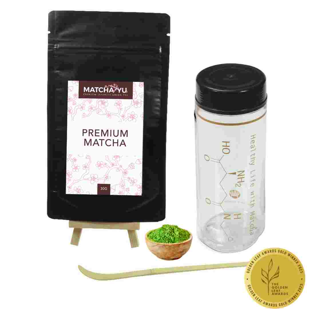 Matcha Yu premium matcha package with a small bowl of matcha, whisk, and scoop on a white background.
