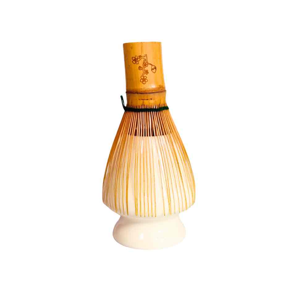 Bamboo whisk with wooden handle on a white background