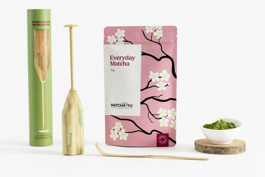 Matcha Yu Tea in cherry blossom pink pouch with electric whisk, bamboo scoop and matcha tea powder